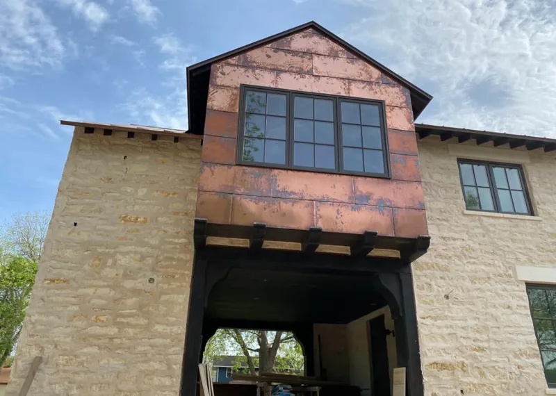 Copper metal panel facade on a stone building for Skylight Installation in Effingham